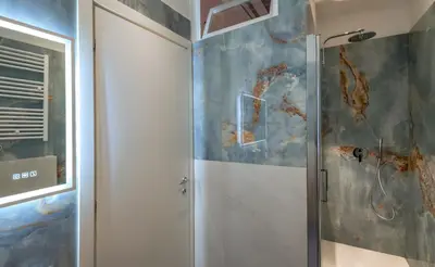 a shower with a glass door in a bathroom at AP Royal suite guesthouse in Rome
