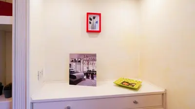 a room with a table with a picture on the wall at La Casa che Vorrei in Rome