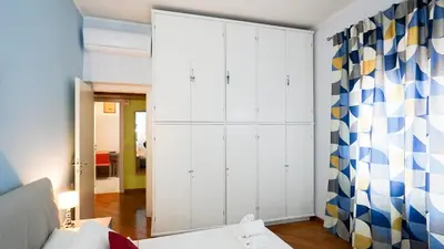 a bedroom with white cabinets and a mirror at La Casa che Vorrei in Rome