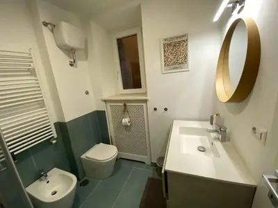 a bathroom with a sink and a toilet and a mirror at LovingRome Colosseum in Rome