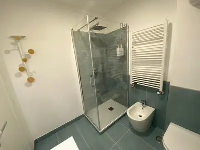 a bathroom with a shower and a toilet at LovingRome Colosseum in Rome