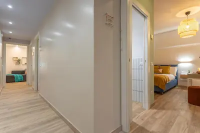 a hallway leading to a bedroom with a bed at Le Muse Suites in Rome