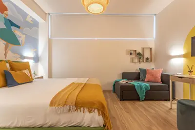 a bedroom with a bed and a couch at Le Muse Suites in Rome