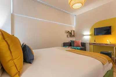 a hotel room with a bed and a tv at Le Muse Suites in Rome