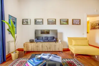 a living room with a couch and a table at Colosseo MecenArt 77 - Home and More in Rome