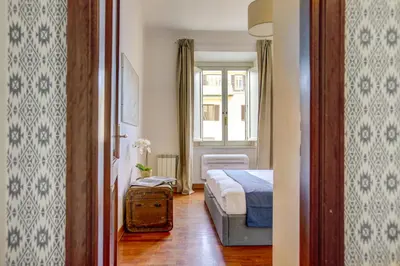 a small bedroom with a bed and a window at Colosseo MecenArt 77 - Home and More in Rome