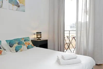 a bedroom with a white bed with a balcony at Trastevere 3 apartments by Flatinrome in Rome