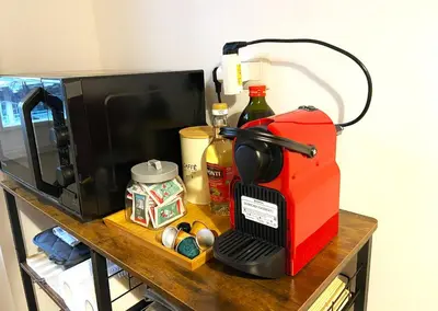 a coffee maker on a table next to a microwave at Trastevere Advenida in Rome
