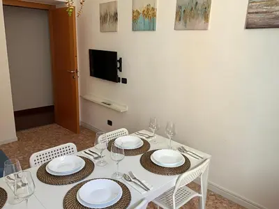 a white table with chairs and plates and wine glasses at Maria House Saint Peter in Rome