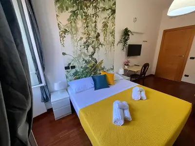a bedroom with two beds with towels on them at Maria House Saint Peter in Rome