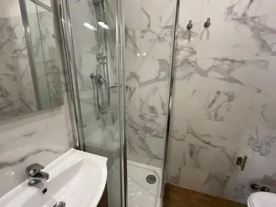 a white bathroom with a sink and a shower at Maria House Saint Peter in Rome