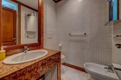a bathroom with a sink and a toilet at Vatican Luxury Suite Bragadin in Rome