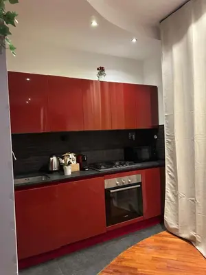 a kitchen with red cabinets and a stove at Balduina 225 in Rome
