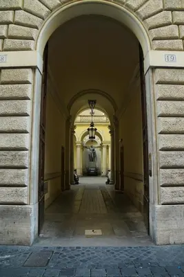 an empty hallway of a building with an archway at FLOUR SUITE - Rome Apartment in Rome