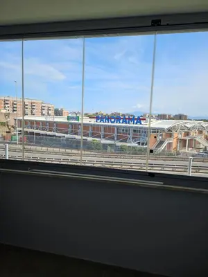 a window in a building with a view of an airport at Two bedrooms with terrace in Rome