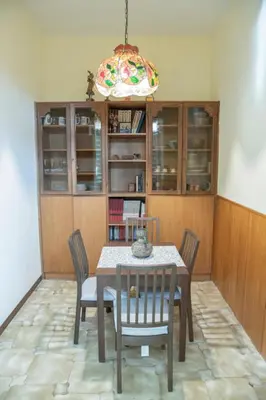 a dining room with a table and chairs and a chandelier at RHome City Garden in Rome