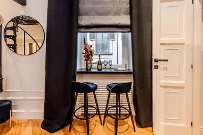 a black curtain in a kitchen with two stools at Acque Romane Fontana di Trevi M in Rome