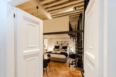 a bedroom with a bed in a room with a loft at Acque Romane Fontana di Trevi M in Rome