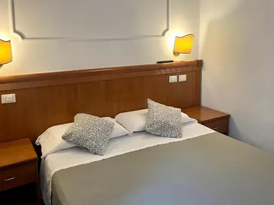 a bedroom with a bed with two pillows on it at La casa di raffy in Rome