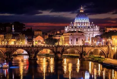 a bridge over a river with a building at night at Angelo ai Musei Vaticani bilocale in Rome