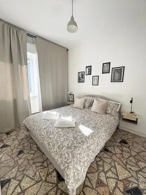 a bedroom with a large bed in a room at Mopy Apartment in Rome
