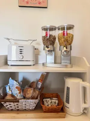 a kitchen shelf with a toaster and food at Mopy Apartment in Rome