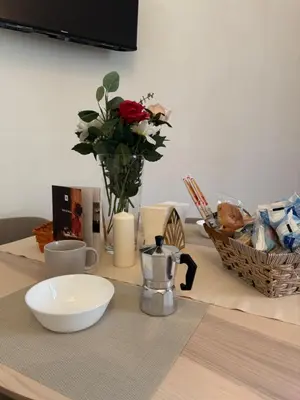 a table with a vase of flowers on a table at Mopy Apartment in Rome