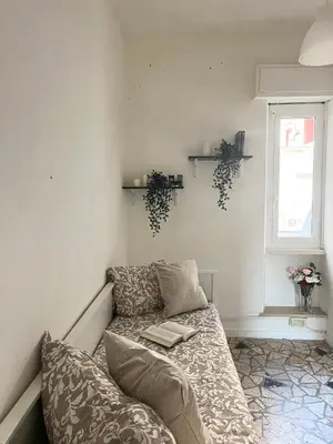 a living room with a couch and a window at Mopy Apartment in Rome