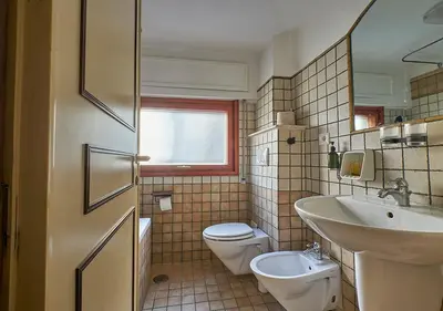 a bathroom with a toilet and a sink at Crimson Guest House in Rome