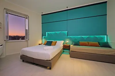 a bedroom with a bed and a couch at Domus Augustea - San Giovanni Sunset Suites in Rome