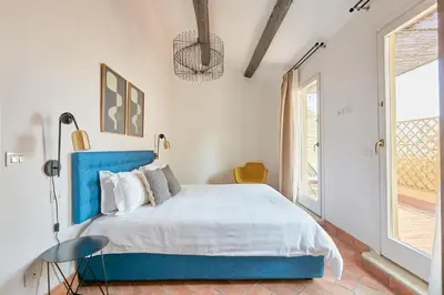 a bedroom with a large bed with a blue headboard at Montevecchio Boutique Apartments in Rome