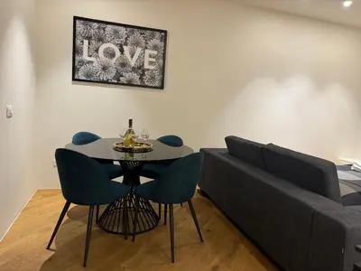 a living room with a table and a couch at Bellina Suite Hi Tech Apartment in Rome