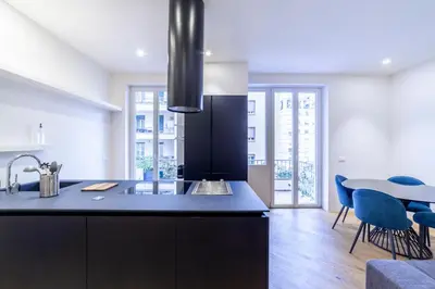 a kitchen with a sink and a table with chairs at Bellina Suite Hi Tech Apartment in Rome
