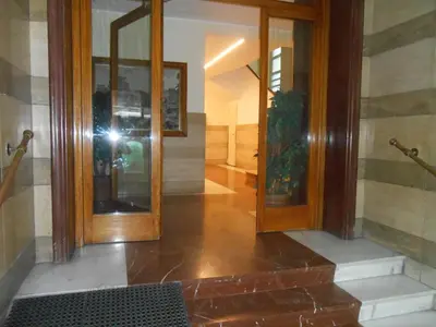 a person taking a picture of a hallway with a mirror at Via Cipro in Rome