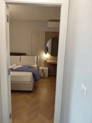 a bedroom with a bed and a mirror at Via Cipro in Rome