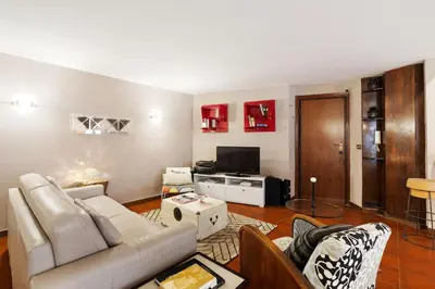 a living room with a table and a dining room at Trastevere Lovely Apartment in Rome