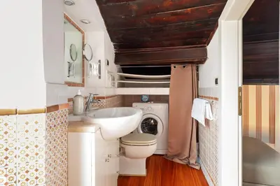 a bathroom with a sink and a toilet and a mirror at Trastevere Lovely Apartment in Rome