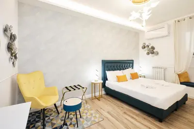 a bedroom with a bed and a table and chairs at 5 minutes from the Vatican - Elegant flat - Wi-Fi in Rome