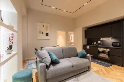 a living room with a couch and a tv at Vatican Charming RHome in Rome