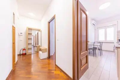 a large mirror in a hallway with a dining room at Easy Host Apt Casa Numitore in Rome