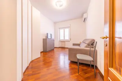 a living room with a couch and a chair at Easy Host Apt Casa Numitore in Rome