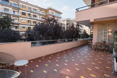 a balcony of a building with tables and chairs at Trionfale Home in Rome