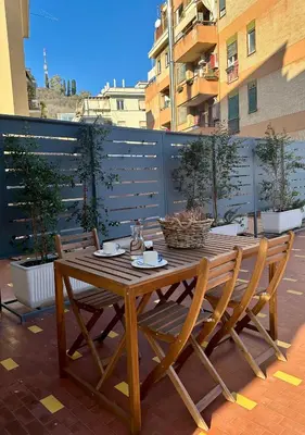 a wooden table and chairs sitting on a patio at Trionfale Home in Rome