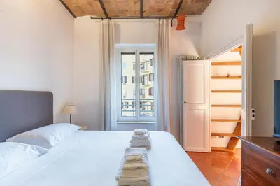 a bedroom with a bed with two towels on it at Maison Colosseo in Rome