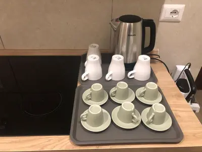 a tray with cups and saucers and a coffee pot at B&B Rome Vatican Residence in Rome