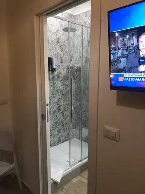 a sliding glass door with a television in a room at B&B Rome Vatican Residence in Rome