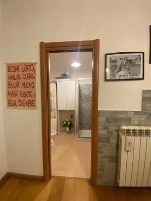 a bathroom with a door open to a room with a toilet at LaCasitaDeAU - Trastevere-Monteverde-Vaticano in Rome