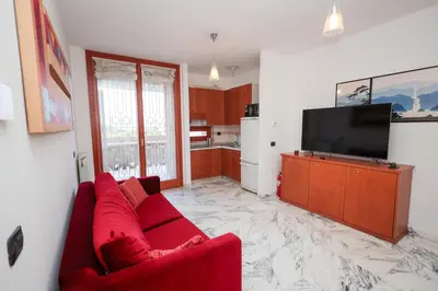 a living room with a red couch and a flat screen tv at La Casa di Piero in Rome