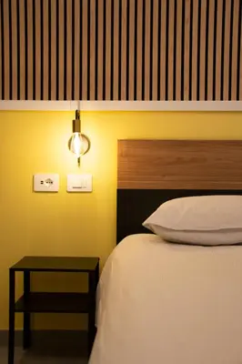 a bedroom with a bed and a side table at Lilium Suites in Rome