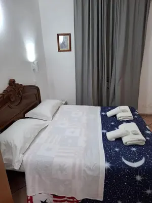 a bedroom with a bed with two towels on it at APARTAMENTO NAPOLEONe 38 in Rome